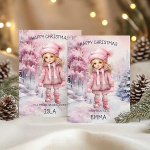 Personalised girls Christmas Card, with a young girl in a snow scene wearing a pink bobble hat and coat.