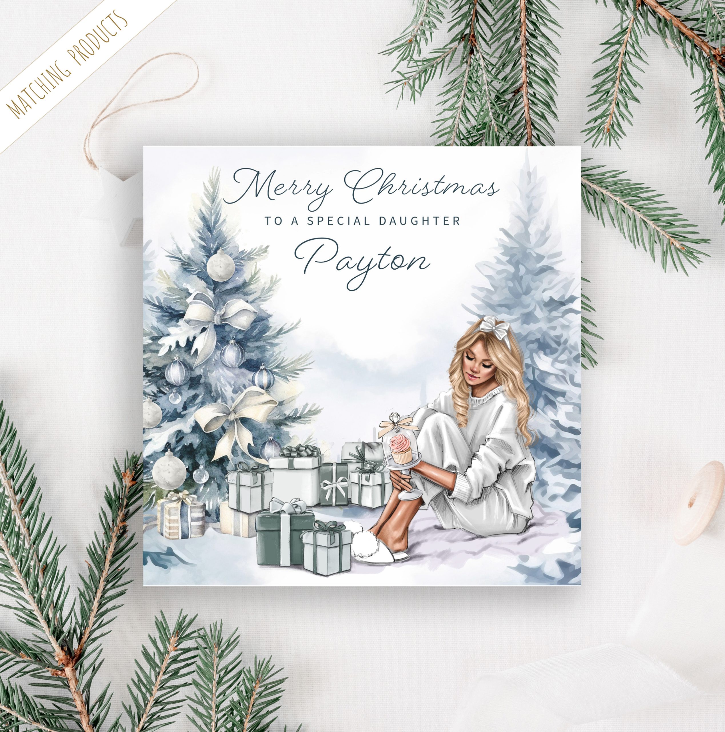 Personalised christmas card with young lady sitting by a Silver Blue Christmas tree with a pile of gifts beneath the tree.