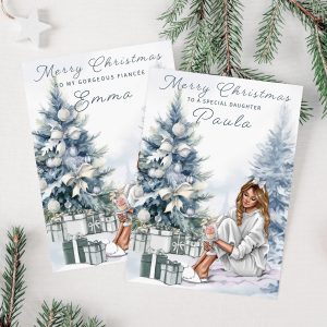 Personalised christmas card with young lady sitting by a Silver Blue Christmas tree with a pile of gifts beneath the tree.