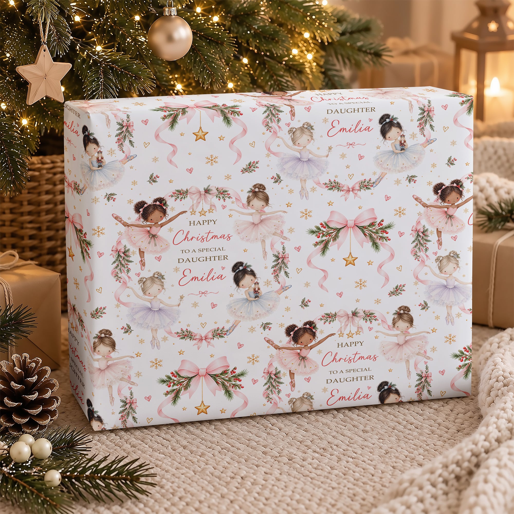 Personalised girls Christmas wrapping paper with ballerina illustrations, delicate pink ribbons, gold stars and a custom printed name.