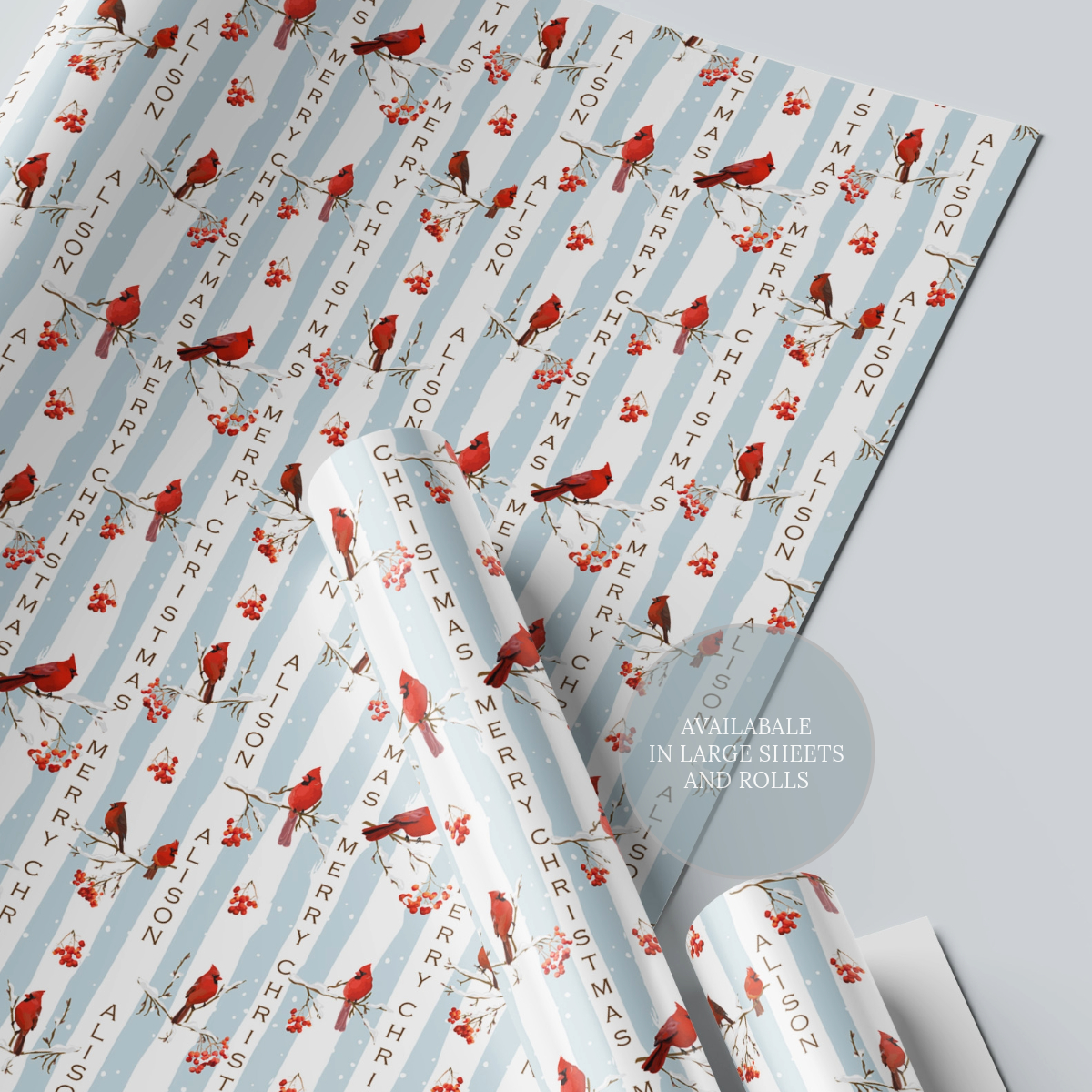Personalised blue stripe christmas wrapping paper with red festive birds perched on snow covered branches.