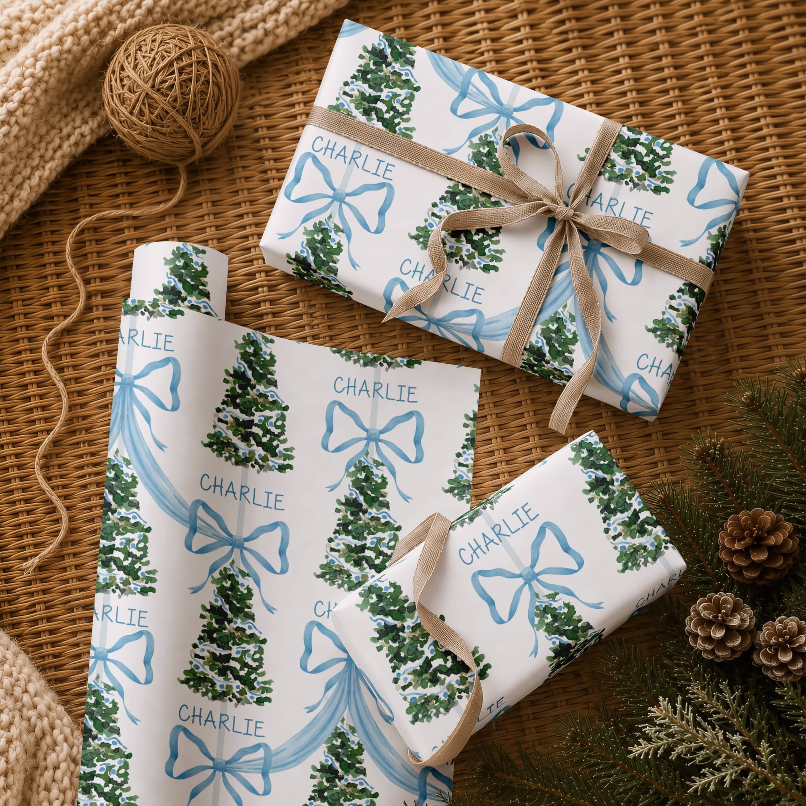 Kids personalised Christmas wrapping paper with blue bows, trees and repeated name