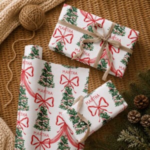 Personalised Christmas tree gift wrap with red ribbon bows and repeated custom name