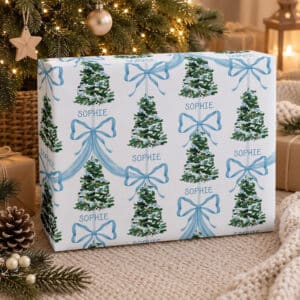 Personalised Christmas wrapping paper with child’s name, blue bows and green trees
