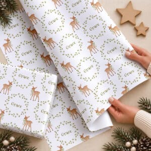 Personalised first Christmas wrapping paper with deer wreath design and child's name