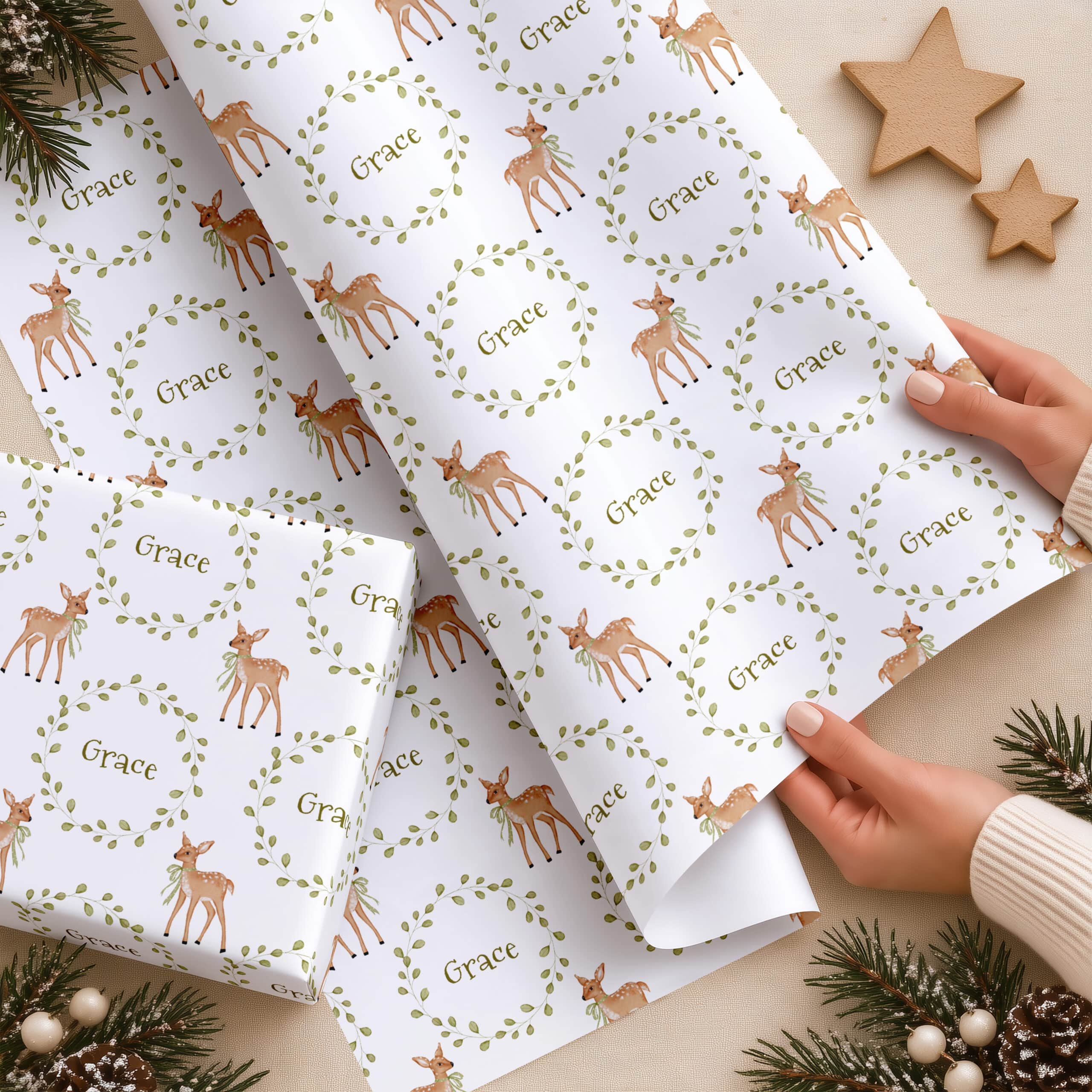 Personalised first Christmas wrapping paper with deer wreath design and child's name