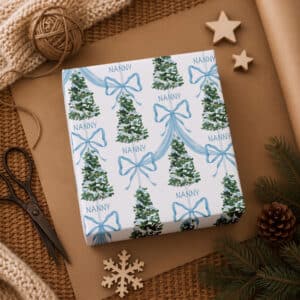 Personalised name Christmas gift wrap for children with blue bows and festive trees