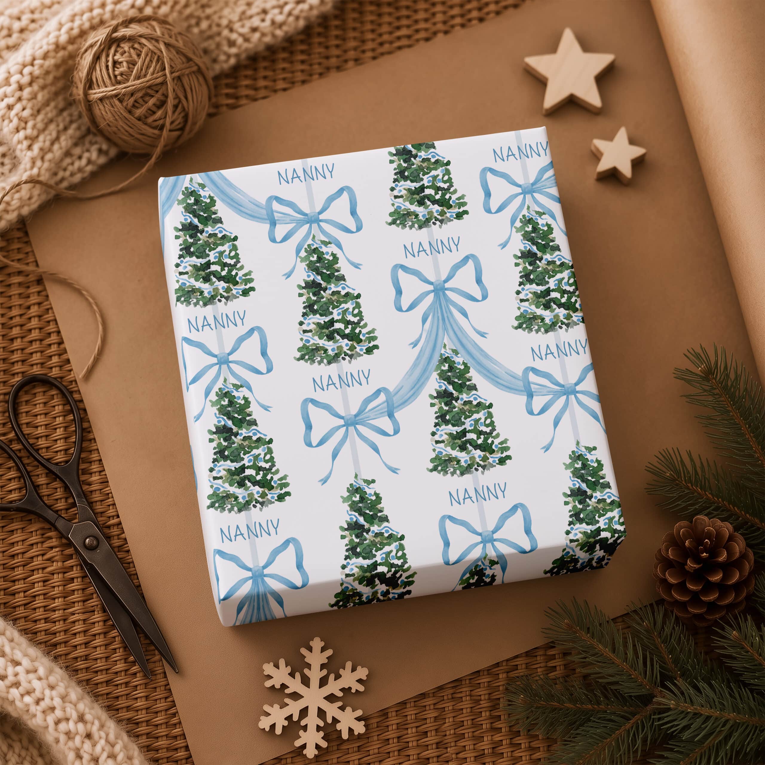 Personalised name Christmas gift wrap for children with blue bows and festive trees