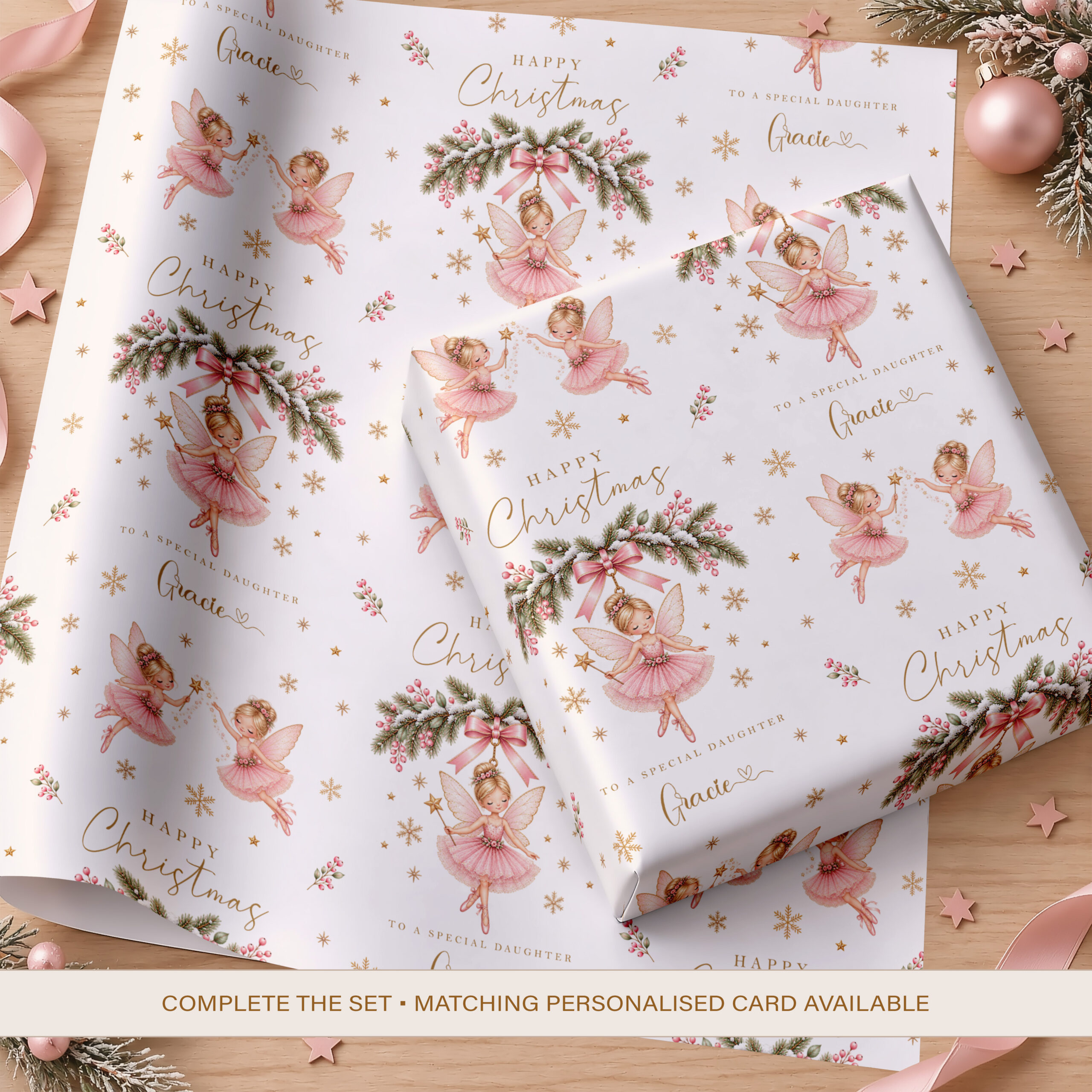 Personalised girls Christmas wrapping paper with pink fairies, festive greenery and name