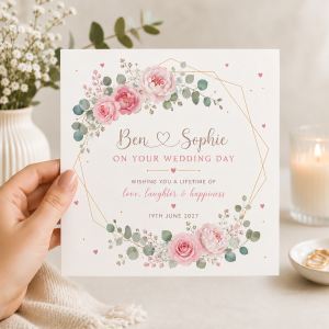 Personalised pink floral wedding card held in hand