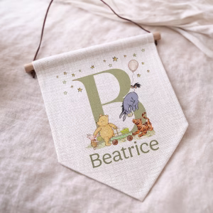 Personalised winnie the pooh nursery linen wall pennant with matching personalised nursery gift collection including cards, mugs, gift wrap, money pots and cushions.