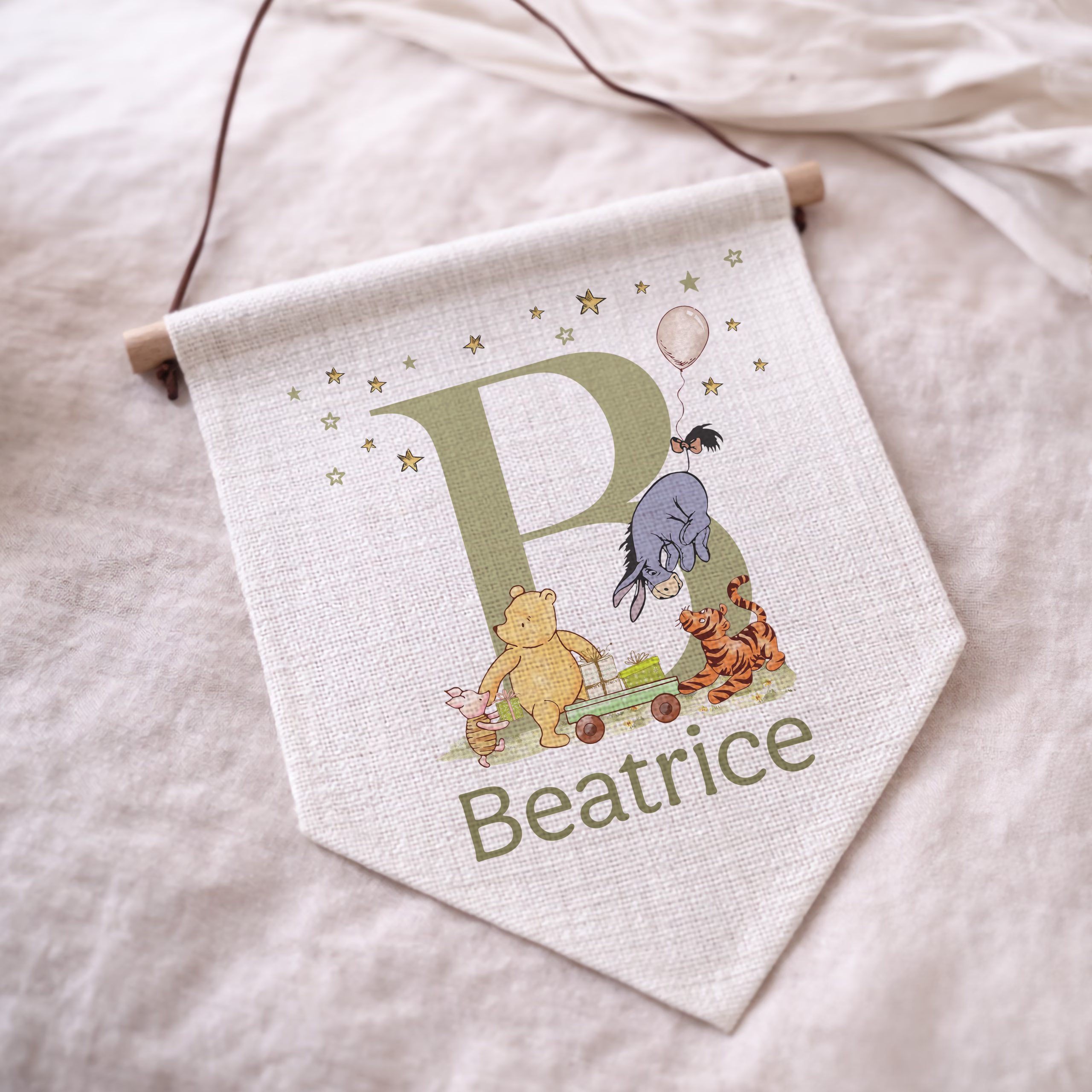 Personalised winnie the pooh nursery linen wall pennant with matching personalised nursery gift collection including cards, mugs, gift wrap, money pots and cushions.
