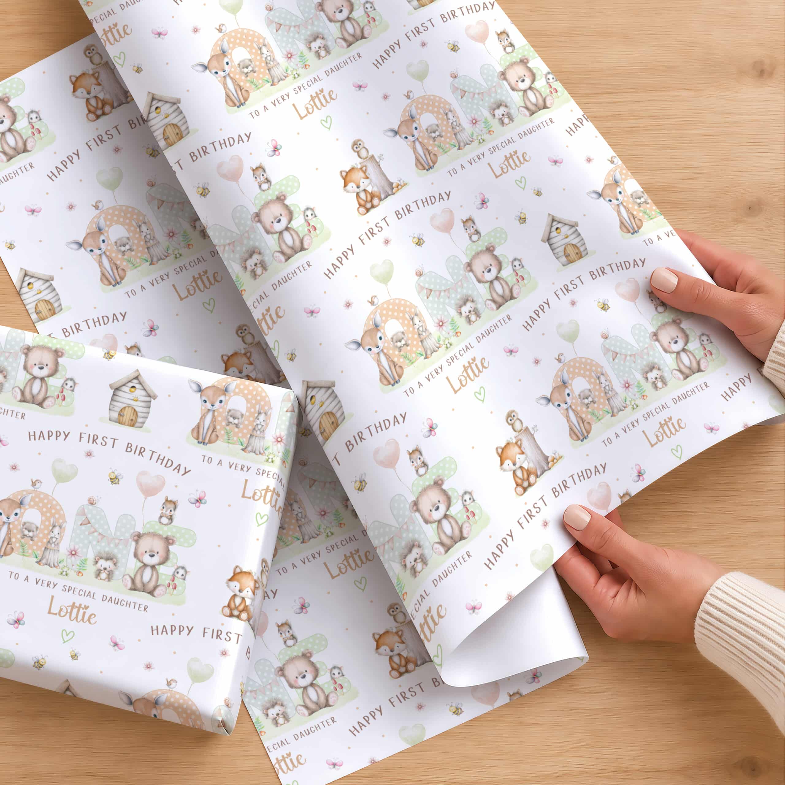 Personalised first birthday wrapping paper with woodland animal design and name