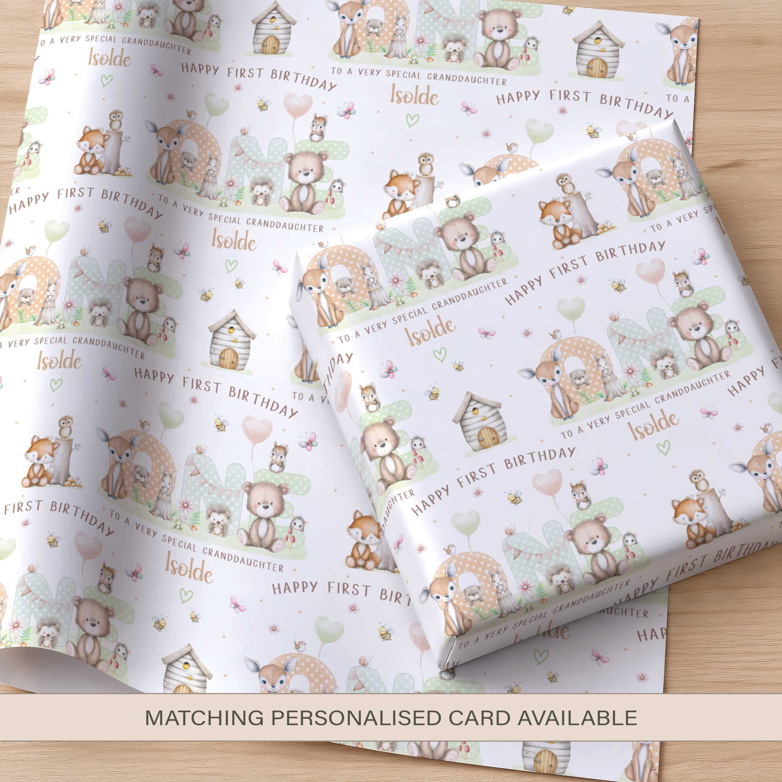 Personalised first birthday wrapping paper for a boy featuring woodland animals and the name