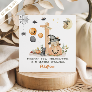 personalised baby's 1st halloween card featuring a cute teddy bear in a pumpkin, set against an orange number one with halloween balloons and bats.