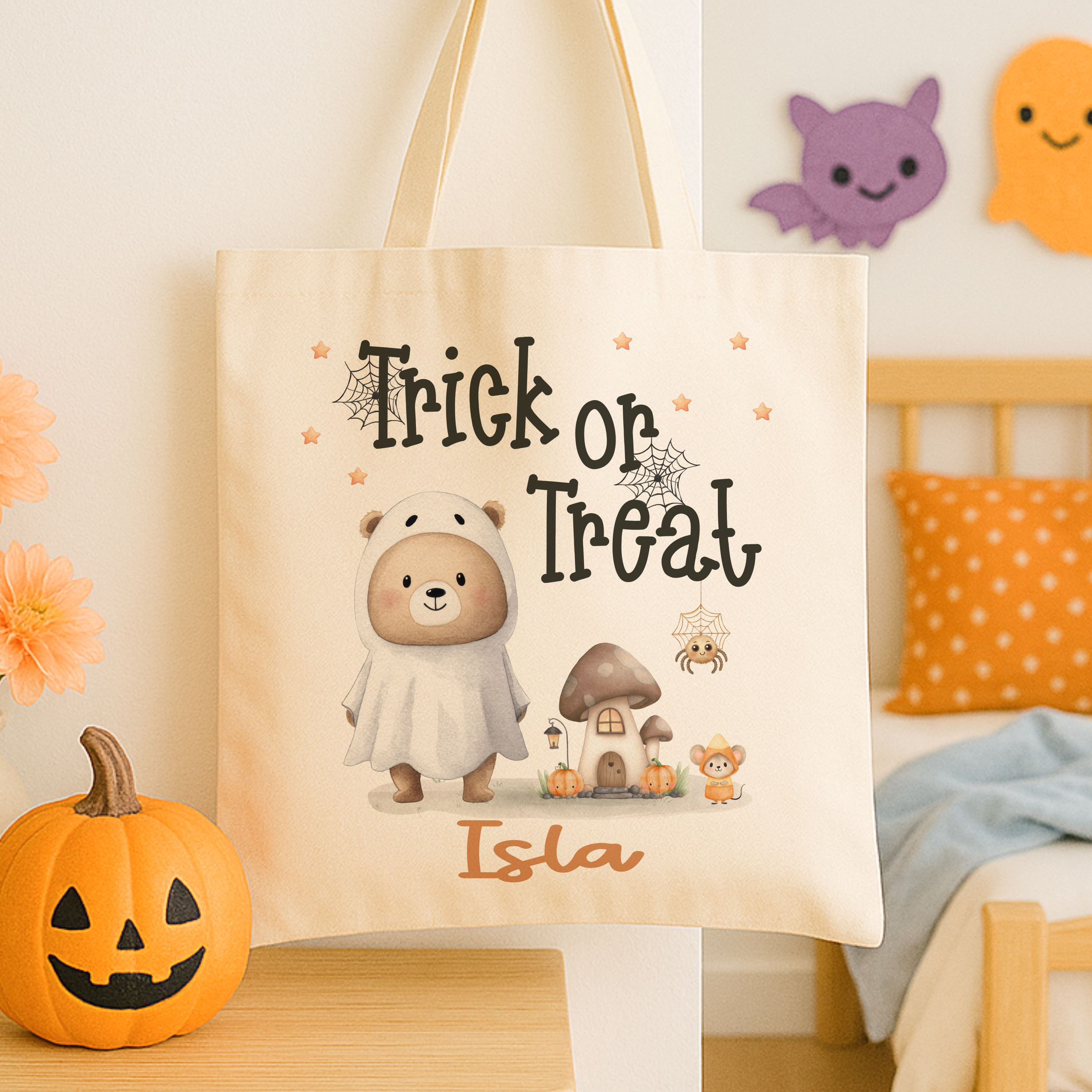 Personalised trick or treat tote bag, with a cute teddy bear design with the childs name added to the bottom in orange print