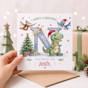 Personalised dinosaur Christmas card for grandson featuring a cute T-Rex, flying dinosaurs, Christmas tree and custom initial with personalised name. Ideal Christmas card for boys, grandchildren and dinosaur lovers.