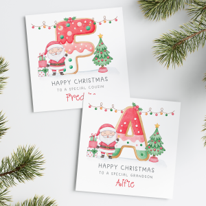 Personalised Kids Christmas Card featuring a large colourful cookie initial. With santa claus and a christmas tree. Personalised with a name at the bottom of the card in red ornate text.
