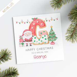 Personalised Kids Christmas Card featuring a large colourful cookie initial. With santa claus and a christmas tree. Personalised with a name at the bottom of the card in red ornate text.