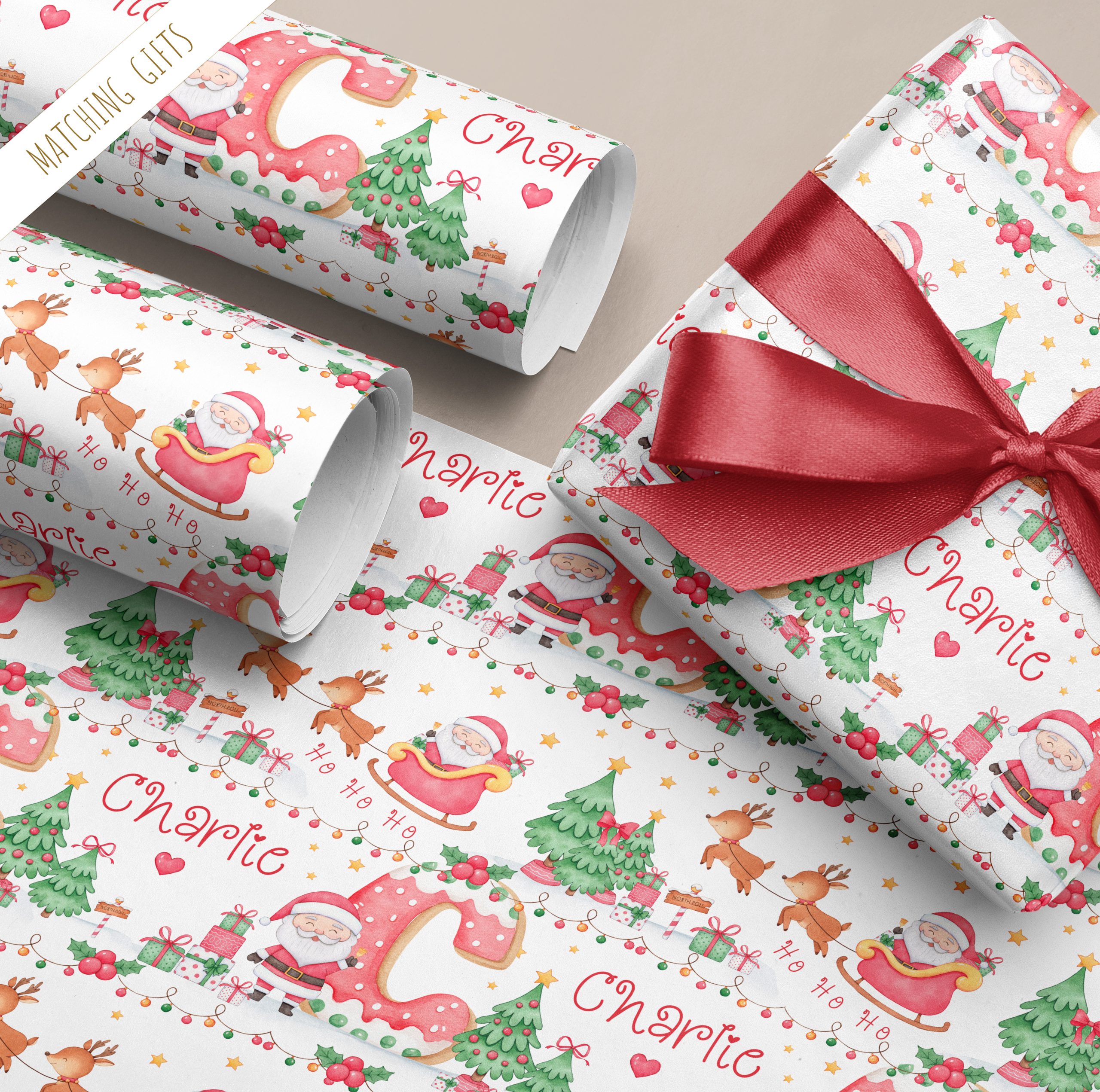 Personalised Christmas Cookie Initial Gift Wrapping Paper. The design shows the name initial in a brightly coloured cookie letter. Surrounded by santa claus in his sleigh with reindeers.