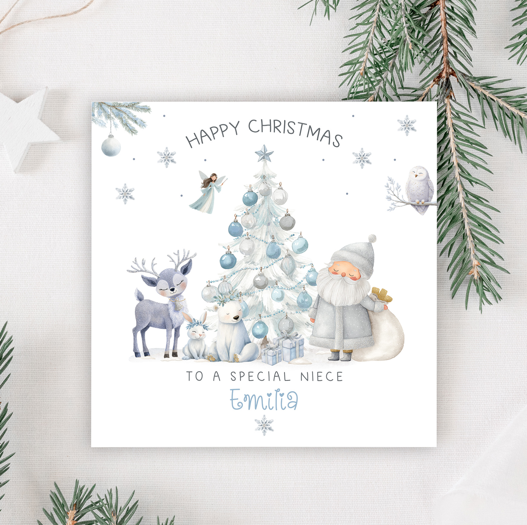 Personalised Frozen Christmas Card, featuring frosty frozen characters around a blue christmas tree. Personalised at the bottom with the name in a christmassy ornate blue font.