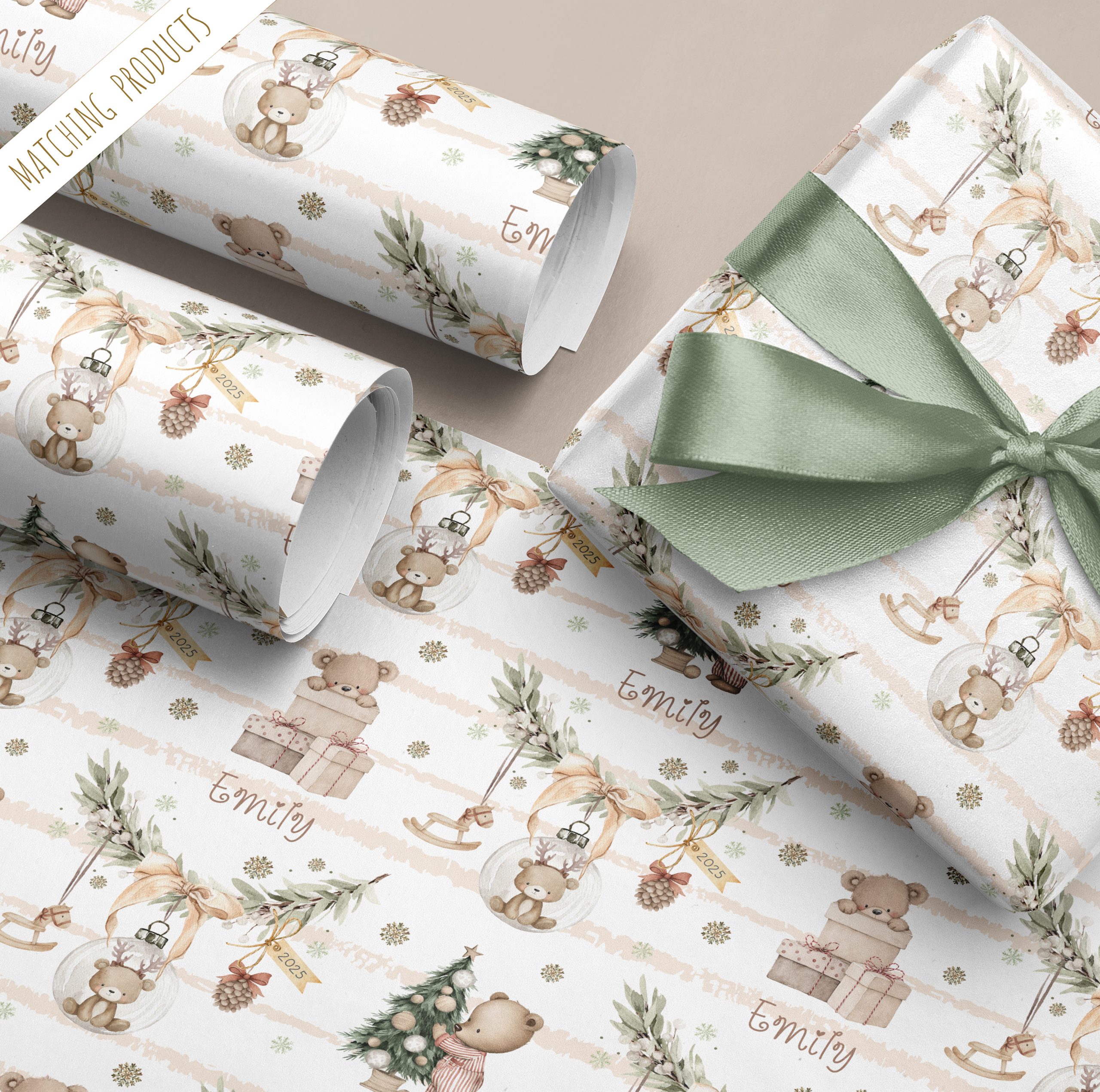 Personalised Baby's 1st Christmas Gift Wrapping Paper Featuring a cute brown teddy bear inside a bauble hanging from a pine branch, with a beige background stipe with a teddy bear standing by a christmas tree wearing stripe Pyjamas. Baby's Names in added to the gift wrapping paper in an ornate chrismassy font.