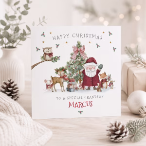 Cute personalised First Christmas card for a grandson featuring Santa and woodland animals with custom name.