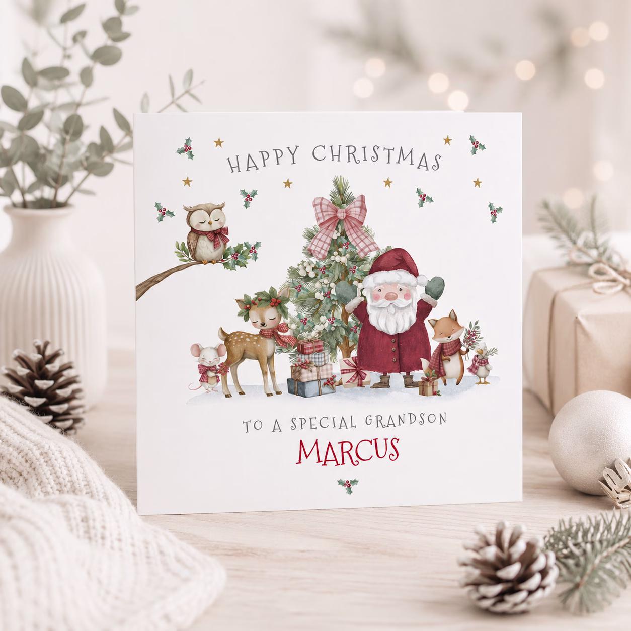 Cute personalised First Christmas card for a grandson featuring Santa and woodland animals with custom name.