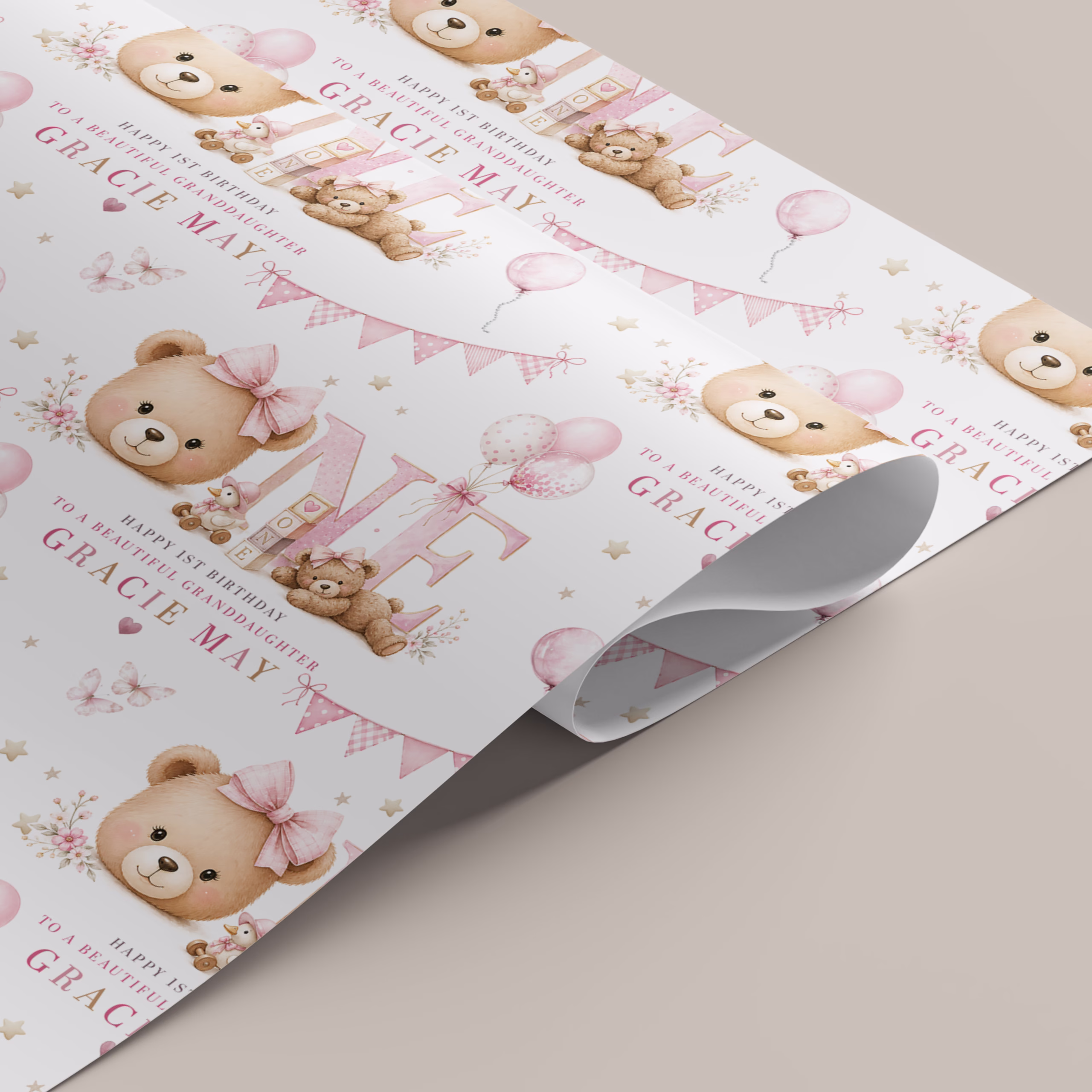 Personalised girls first birthday gift wrapping paper with a soft pink teddy bear, balloons, bunting and large number one