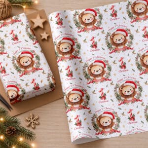 First Christmas wrapping paper with a watercolour lion, red and cream striped number one, Christmas ribbons and festive decorations.