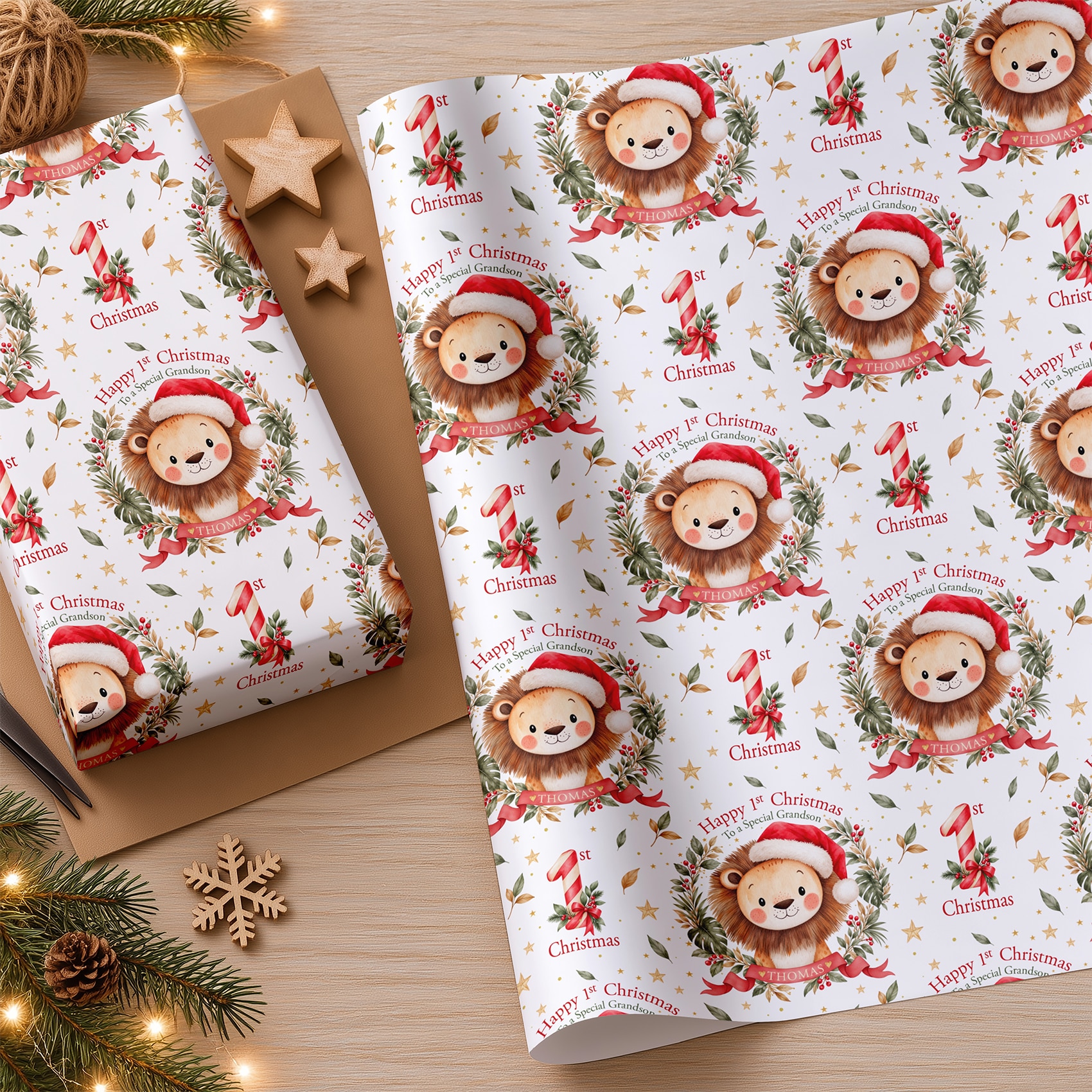 First Christmas wrapping paper with a watercolour lion, red and cream striped number one, Christmas ribbons and festive decorations.