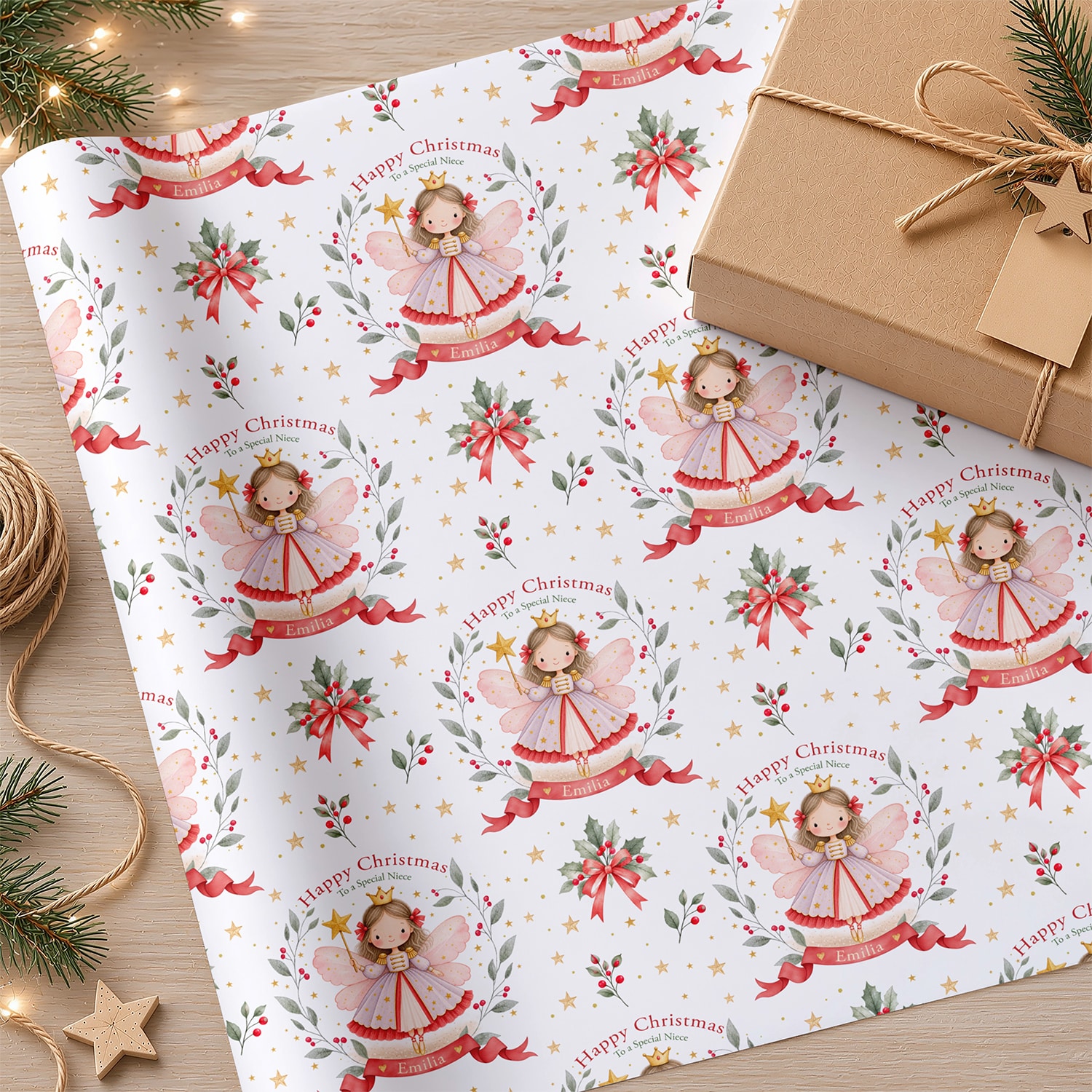 Custom name Christmas wrapping paper with repeating fairy illustrations, red ribbon banners, botanical sprigs and gold stars.